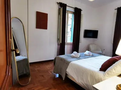 a bedroom with a bed with a mirror and a window at Key apartments Vatican Flat in Rome