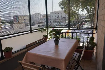a table in a balcony with a view of a city at Stazione Trastevere Apartment in Rome