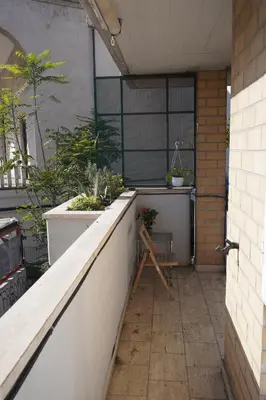 a balcony with a counter with plants on it at Stazione Trastevere Apartment in Rome