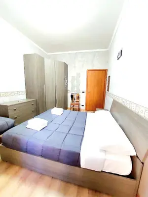 a bedroom with a large bed and a couch at Trastevere in Station in Rome