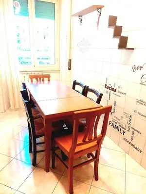 a wooden table and chairs in a room at Trastevere in Station in Rome