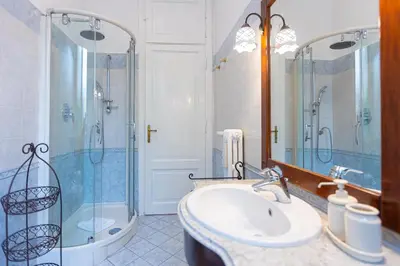 a bathroom with a sink and a shower and a mirror at Clodia 5 by Rental in Rome in Rome