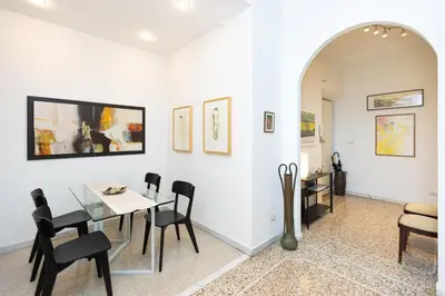 a dining room with a table and chairs at Clodia 5 by Rental in Rome in Rome