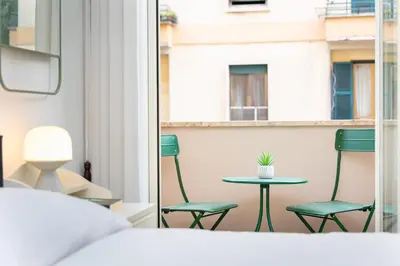 a room with two chairs and a table on a balcony at Clodia 5 by Rental in Rome in Rome