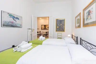two beds in a room with white walls at Clodia 5 by Rental in Rome in Rome