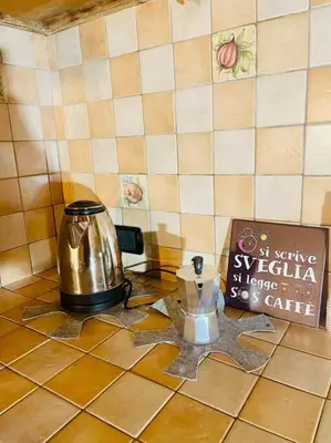 a tea kettle on a counter next to a sign at Minicasa Vatican in Rome