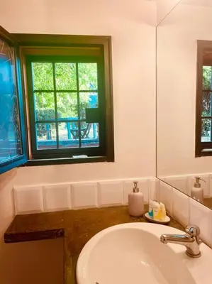 a white bathroom with a sink and a window at Minicasa Vatican in Rome