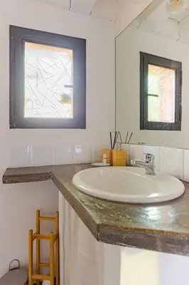 a white bathroom with a sink and a mirror at Minicasa Vatican in Rome