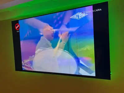 a television screen with a picture of a person stirring a pot at Historical Houses in Rome
