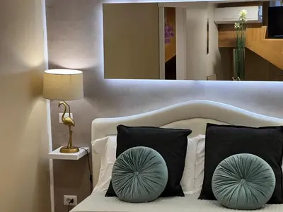 a bedroom with a bed with two pillows and a mirror at Historical Houses in Rome