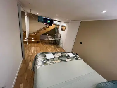 a small room with a bed and a staircase at Historical Houses in Rome