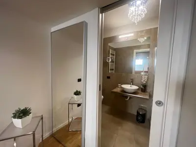 a bathroom with a sink and a mirror at Historical Houses in Rome