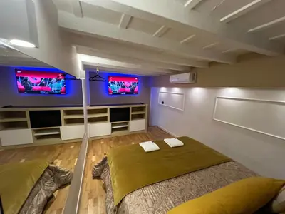 a bedroom with a bed and two televisions on the wall at Historical Houses in Rome