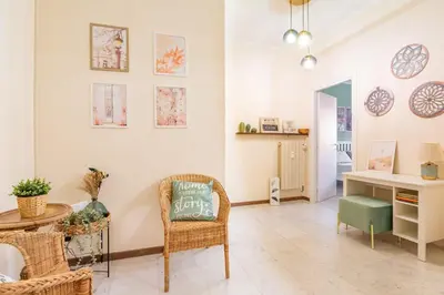 a living room with a table and a chair at Roma is amoR in Rome