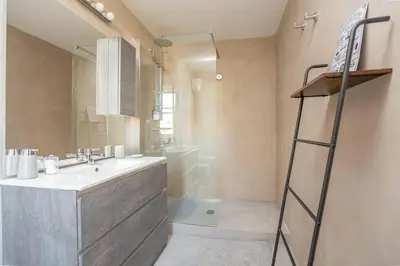 a bathroom with a sink and a shower and a ladder at Roma is amoR in Rome