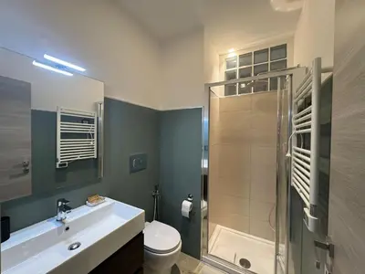 a bathroom with a toilet and a sink and a shower at Laura's house in Alberone in Rome