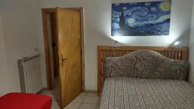a bedroom with a bed and a painting on the wall at Saint Peter Apartment in Rome