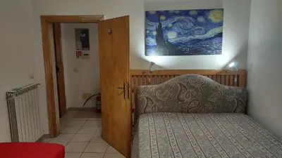 a bedroom with a couch and a painting on the wall at Saint Peter Apartment in Rome
