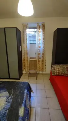 a room with a bed and a window and a room with at Saint Peter Apartment in Rome