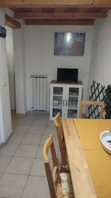 a dining room with a table and a kitchen at Saint Peter Apartment in Rome