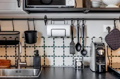 a kitchen counter with utensils on the wall at Atelier Gianicolo Suite in Rome