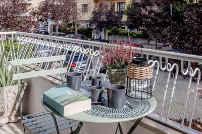 a table with books and cups on a balcony at Atelier Gianicolo Suite in Rome