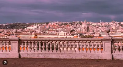a view of a city from behind a fence at Atelier Gianicolo Suite in Rome