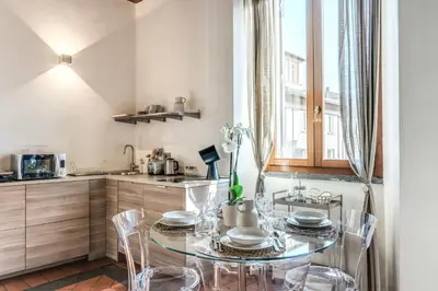 a dining room with a table and chairs in a kitchen at Casa Navona Apartments in Rome