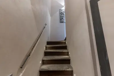 a stairway leading up to a room with white walls at Casa Navona Apartments in Rome