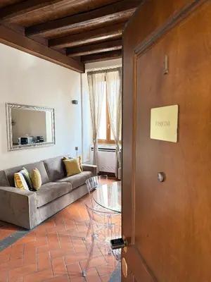 a living room with a couch and a door at Casa Navona Apartments in Rome