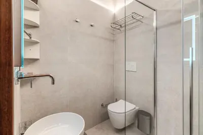 a bathroom with a toilet and a glass shower at Casa Navona Apartments in Rome