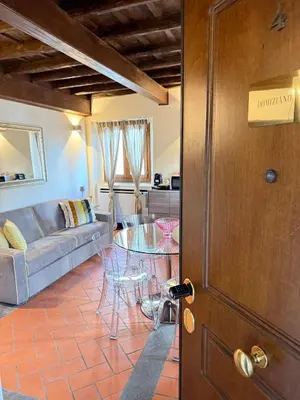 a living room with a couch and a glass table at Casa Navona Apartments in Rome