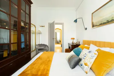 a bedroom with a bed and a chair in it at YCH-Belle Epoque House in Rome