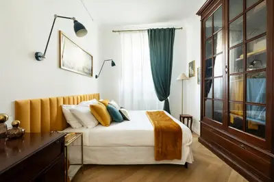 a bedroom with a bed with white sheets and yellow pillows at YCH-Belle Epoque House in Rome