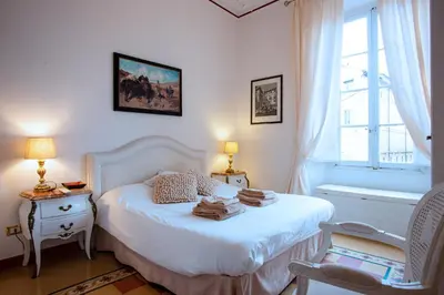 a bedroom with a white bed and a window at Il sogno delle tartarughe in Rome