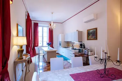 a kitchen and living room with a table and chairs at Il sogno delle tartarughe in Rome