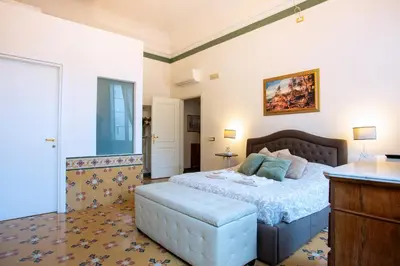 a bedroom with a large bed and a table at Il sogno delle tartarughe in Rome