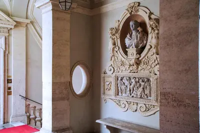 a statue on a wall in a room with a mirror at Il sogno delle tartarughe in Rome