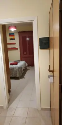 an empty hallway with two doors and a tile floor at DàLù alPigneto in Rome