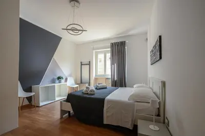 a bedroom with a large bed and a window at La Casa Sui Musei Vaticani in Rome