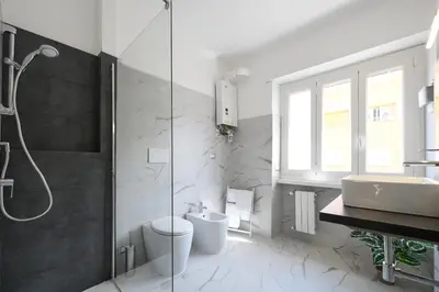 a bathroom with a shower and a toilet and a sink at La Casa Sui Musei Vaticani in Rome