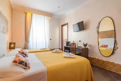 a bottle of wine and a lamp on a table at Alis Laura - 10 mins to Colosseum, Modern & Near Metro in Rome