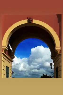 an arch in a building with a blue sky and clouds at B&B Garbatella-Sotto l'arco del Lotto 28 in Rome