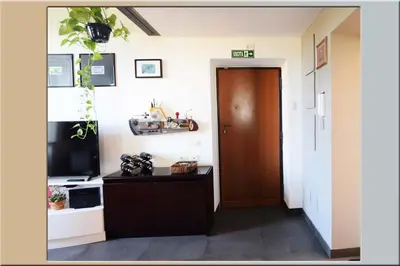 a hallway with a door and a television at B&B Garbatella-Sotto l'arco del Lotto 28 in Rome