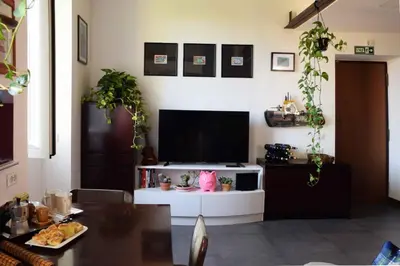 a living room with a tv and a table at B&B Garbatella-Sotto l'arco del Lotto 28 in Rome