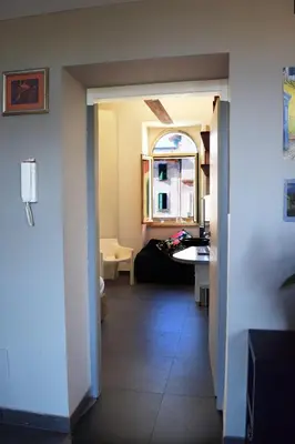 a hallway leading to a living room with a table at B&B Garbatella-Sotto l'arco del Lotto 28 in Rome