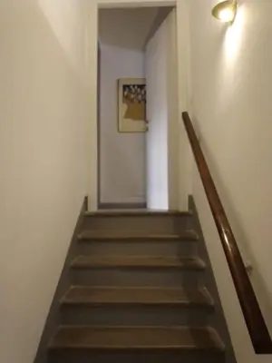 a hallway with stairs with a picture on the wall at Hostapartment SUITE UP in Rome