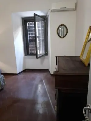 an empty room with a window and a piano at Hostapartment SUITE UP in Rome