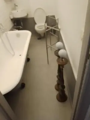 a bathroom with a white toilet and a sink at Hostapartment SUITE UP in Rome