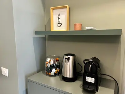 a coffee maker and a coffeemaker sitting on a shelf at Provincie 55 in Rome